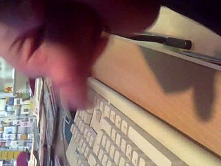 I'm stroking my cock in the internet cafe