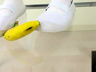 Japanese asian girl performs food crush fetish by crushing a banana