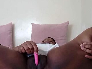 Ebony slut vibrates shaved pussy to creamy orgasm