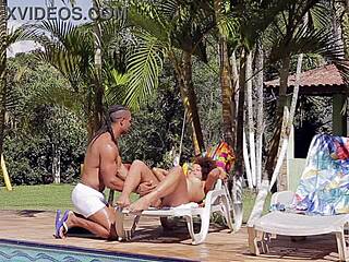 Giovana bombom sucks mauro araujo's monster black cock by the pool.