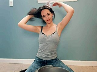 Suggestive Wet Brunette Teases with Soaked Shirt in Bathroom Scene