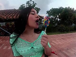 Colombian whore sucks a lollipop while showing her body