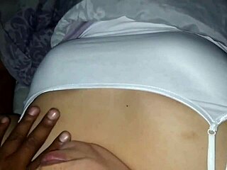 Feeling relaxed on the bed watching TV, she tenderly caresses my breasts