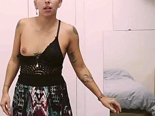 Short tattooed girl rips clothes in teasing striptease