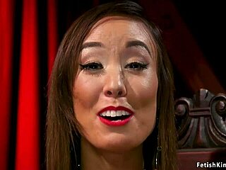 Asian femdom interacts with gimp slave in a bondage session.