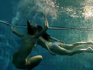 brunette babe poses erotically underwater in swimming pool