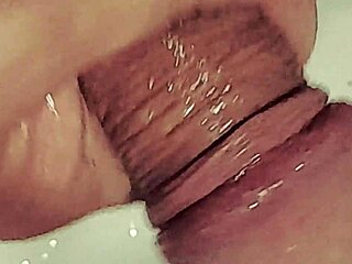 Detailed gay anal fisting scene where a man uses a cucumber for intense penetration.