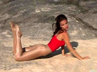 Monika struts in SHINY pantyhose on the beach from ArtOfGloss net