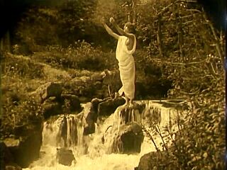 nude woman by waterfall