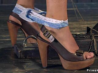 blonde in leather corset endures intense bondage torment