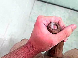 Young twink cums in the shower at home.