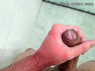 Young twink cums in the shower at home.