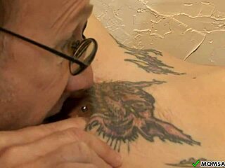 Hey, check this inked blonde milf showing off her tattoos!