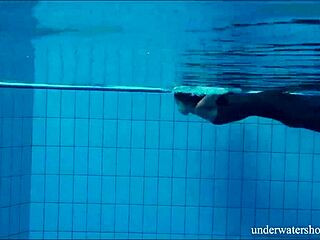 Brunette babe Nata Szilva swims tight in pool