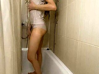 Teen brunette soaking in white underwear during steamy shower.