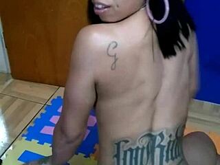 brunette with tattoo sits on console topless for the first time