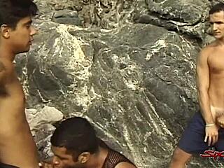 two big dicked dudes rim and blow the tanned twink on the beach