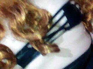 Face mask covers mouth during black dildo play.