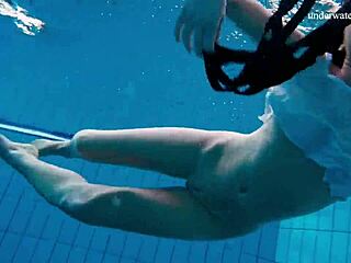 Horny teen 18+ strips naked in public pool. She shows tight pussy underwater.