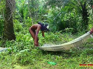 She bent over in the bush, enjoying the pleasure of two big black cocks fucking her hard.