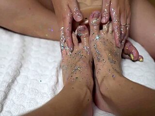 Two cute amateurs with shiny legs tease a huge rubber cock. They give an intense footjob while licking each other.