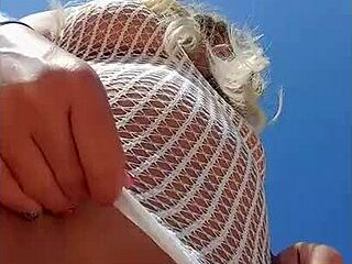 Beautiful young woman in transparent dress without underwear in public