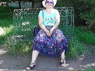 hairy mature woman in a see-through dress outdoors