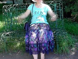 hairy mature woman in a see-through dress outdoors