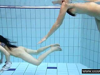 Shaved brunette babe with big tits bathing underwater