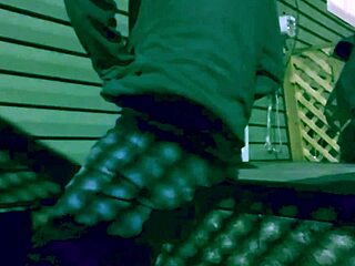 Amateur stretches in leggings outdoors at night with shadows