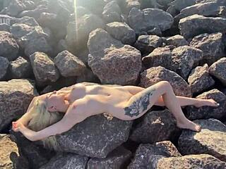 Watch her play with her clit on the beach?