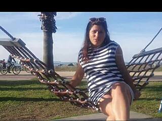 Naked girl bends over on public beach for fetish fun 🌊