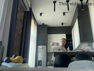 Look at this sexy brunette flashing her shaved pussy while doing housework naked