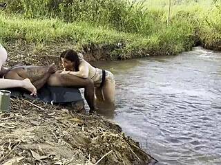 Outdoor Sunbathing By River, Two Women Suck Big Black Cock Then Ride Roughly