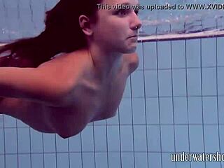 Lucy teasingly takes off her bikini in the pool