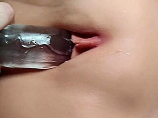 bored girl picking at her shaved pussy with toys close up