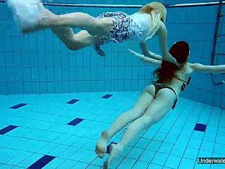 two hot lesbians dive into passionate play in the shimmering pool, exploring every curve underwater