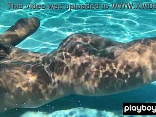 Naked ebony milf Ana Foxxx fingers her hairy black pussy sensually under the water outdoors.