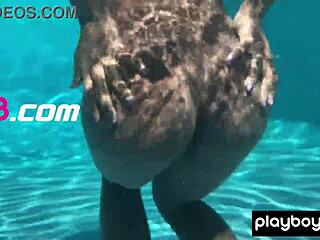 Naked ebony milf Ana Foxxx fingers her hairy black pussy sensually under the water outdoors.