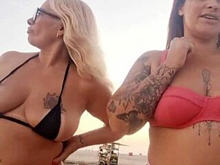 Chatting sexy on beach with naughty friend