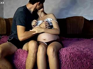 Check out this 9th month pregnant blonde enjoying time with her boyfriend on the couch