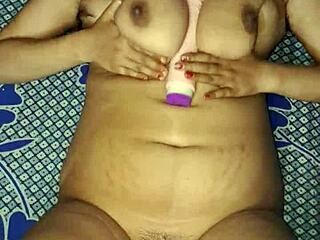 Oh wow, watch this Indian bhabhi with huge natural tits moan as she fucks her wet hairy pussy with a hard dildo!