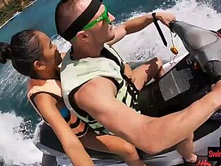 In an adventurous twist the asian girlfriend surprises with a daring public blowjob on a jetski outdoors