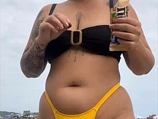 I feel excited wearing tight yellow bikini on beach showing swollen pussy