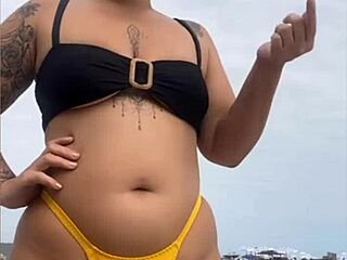 I feel excited wearing tight yellow bikini on beach showing swollen pussy
