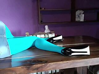 milf with beautiful legs in pantyhose and heels lying on the desk